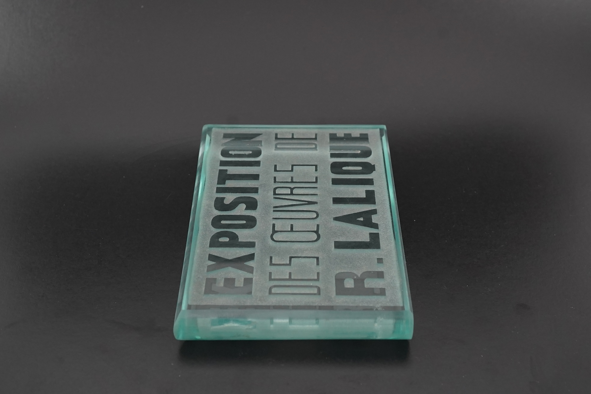 Lalique: A glass advertising plaque 'EXPOSITION DES ŒUVRES DE R.LALIQUE'